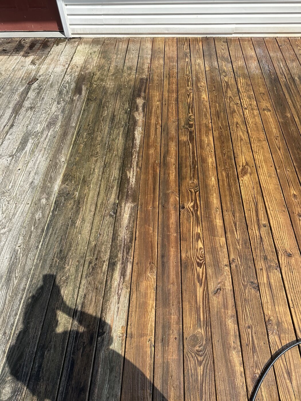Wood deck during cleaning with a clear before and after difference